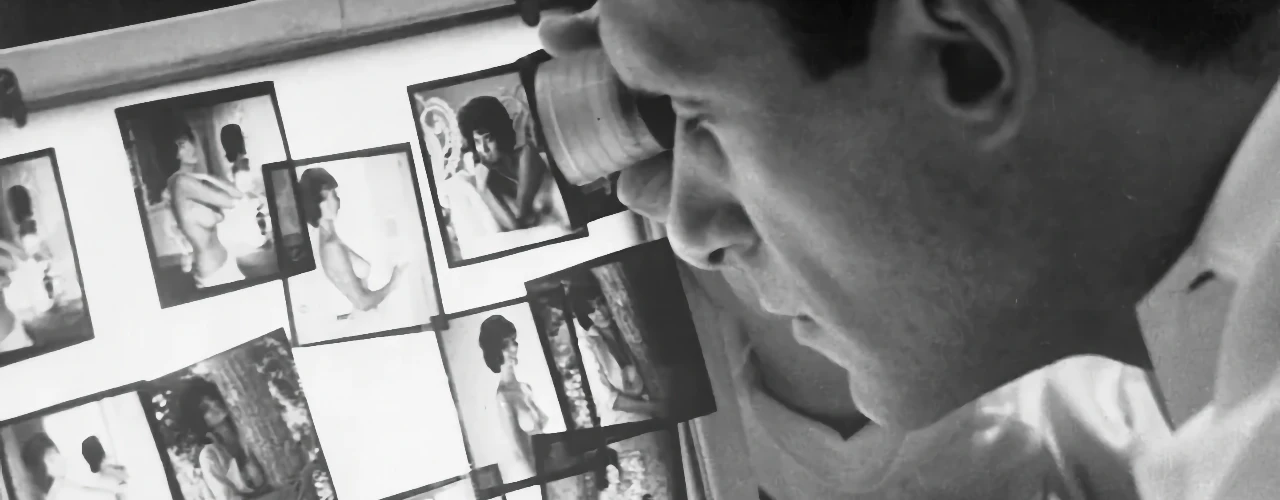 Hugh Hefner reviewing playboy pictorials